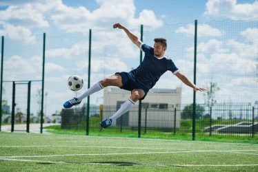 athletic-soccer-player-kicking-ball-on-soccer-pitch-rbpcsvdjtjibfc10nf97swhxeqoy9a4vhhecsx9wxs